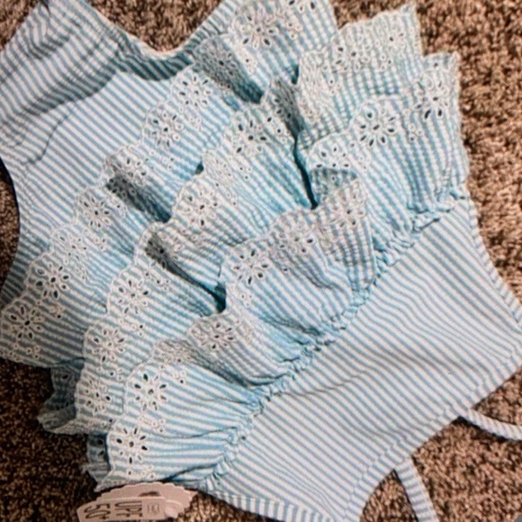Features ruffle accents one piece - Picture 1 of 4